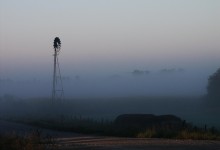 Windmill shrouded in fog at a farm outside of Walker, Iowa